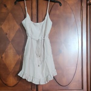 The image shows a Saints and Secrets white frilly shift dress